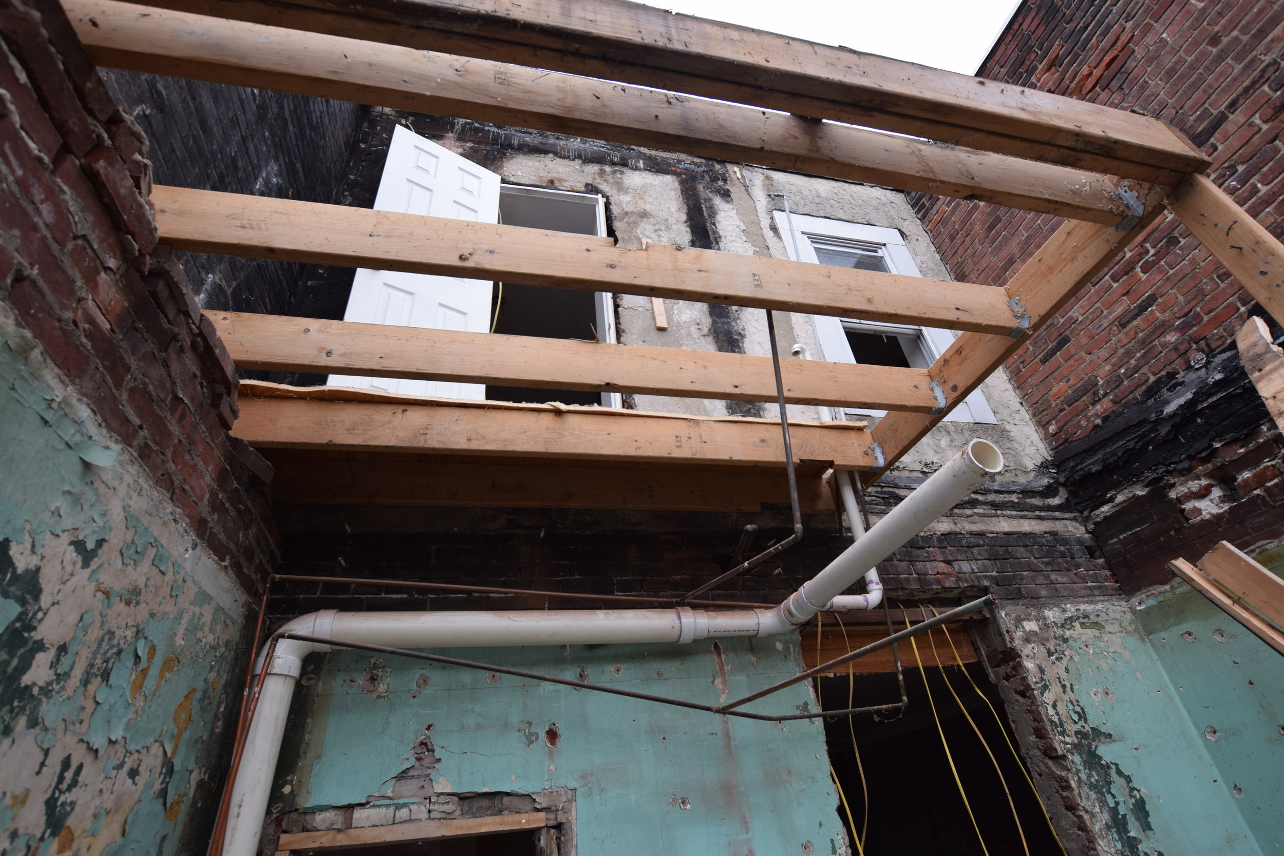 standing in the former kitchen, looking up at the former bathroom (and the sky)